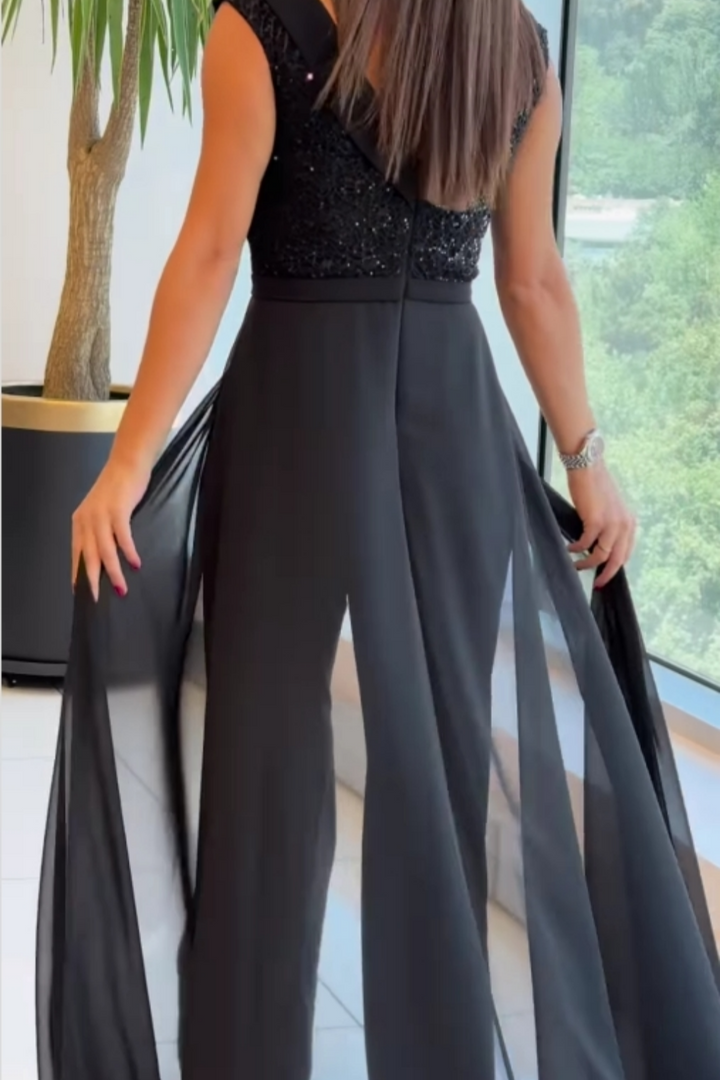 Mono de gala negro con sobrefalda de chifón